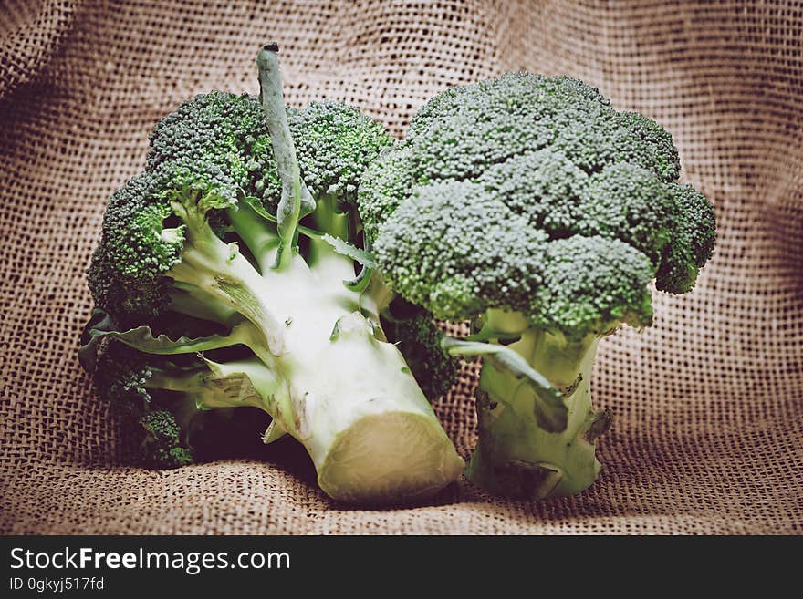 Closeup of broccoli on a burlap sack.