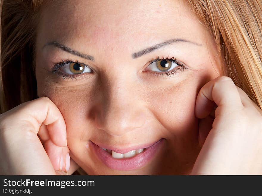 Closeup portrait of pretty young girl (teenager perhaps) highly intelligent and with brown eyes and blond hair.