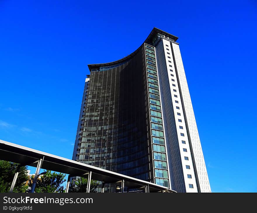 A high rise building, hotel or apartment block against the blue sky.