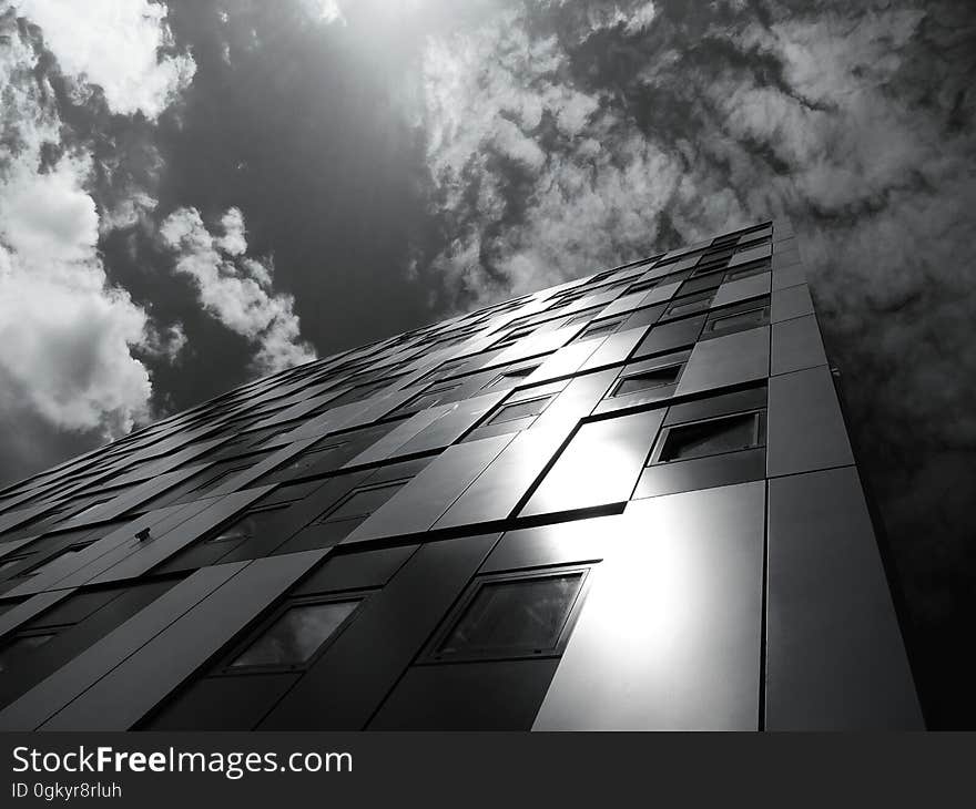 Angled view of a modern building with the sun reflecting off of it.