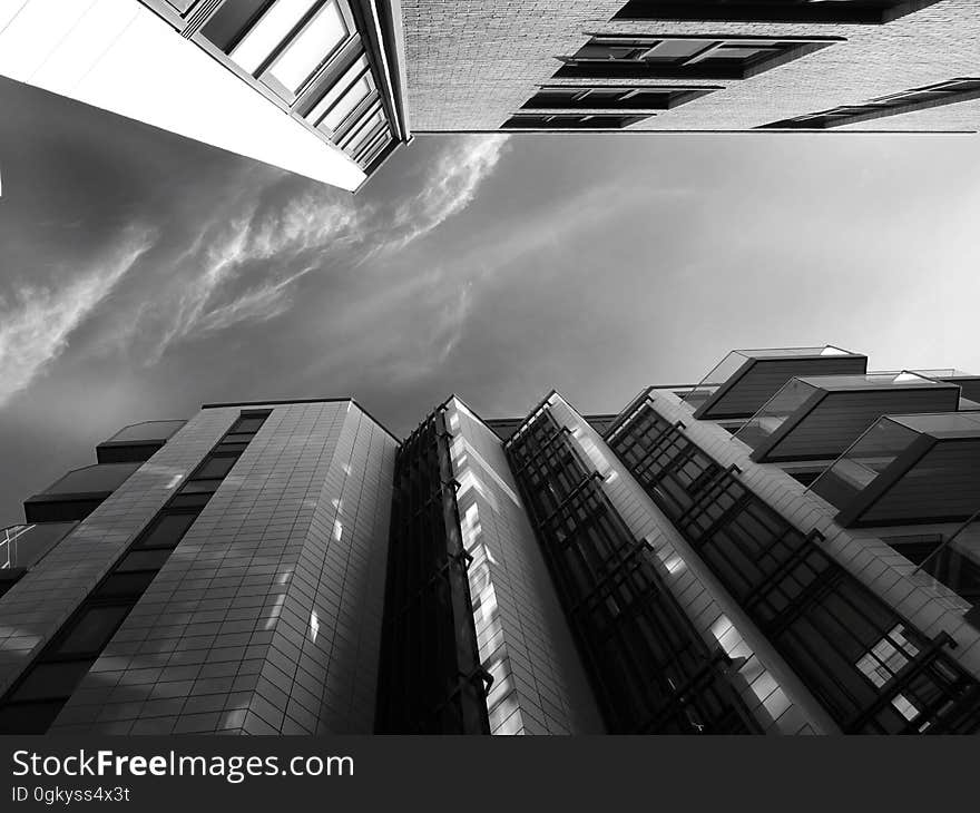 A low-angle view of a city in monochrome. A low-angle view of a city in monochrome.