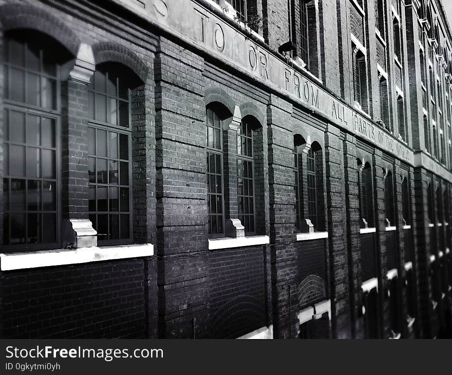 A black and white photo of a brick building.