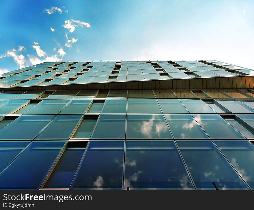 Angled view of a modern, glass building. Angled view of a modern, glass building.