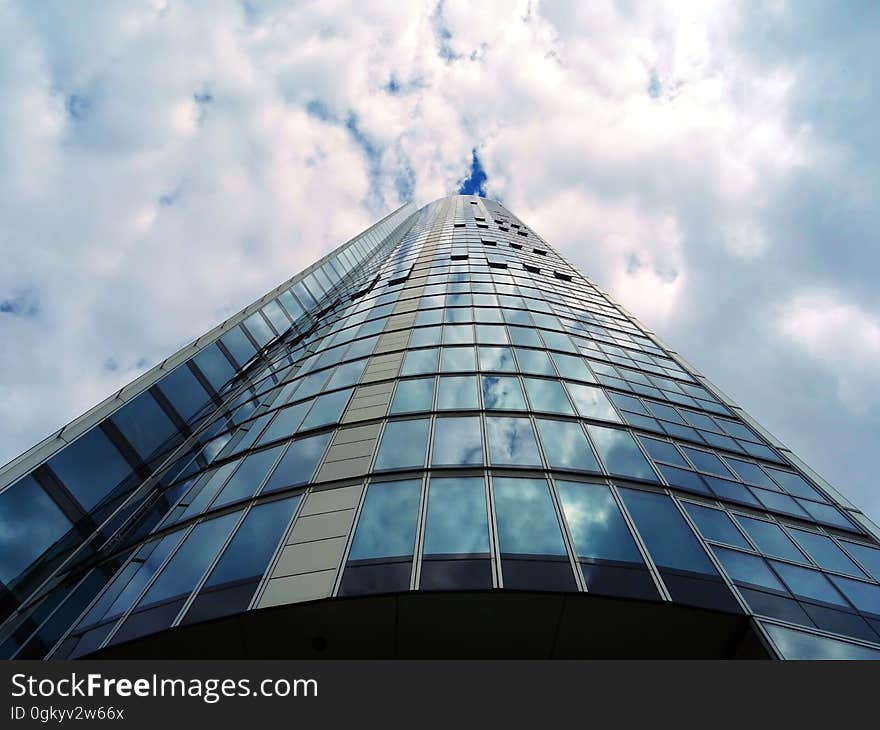 A tall modern glass building from a low angle.