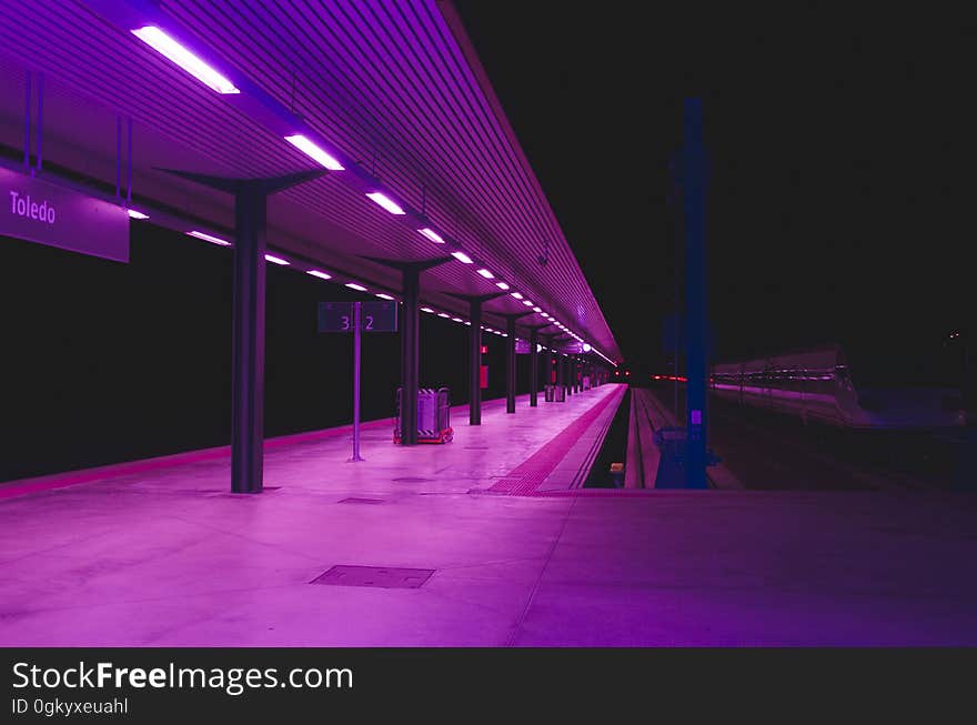 A railway station or a metro platform in purple colored lighting. A railway station or a metro platform in purple colored lighting.