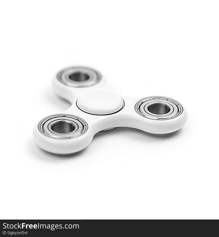 A close up of a white fidget spinner on white background.