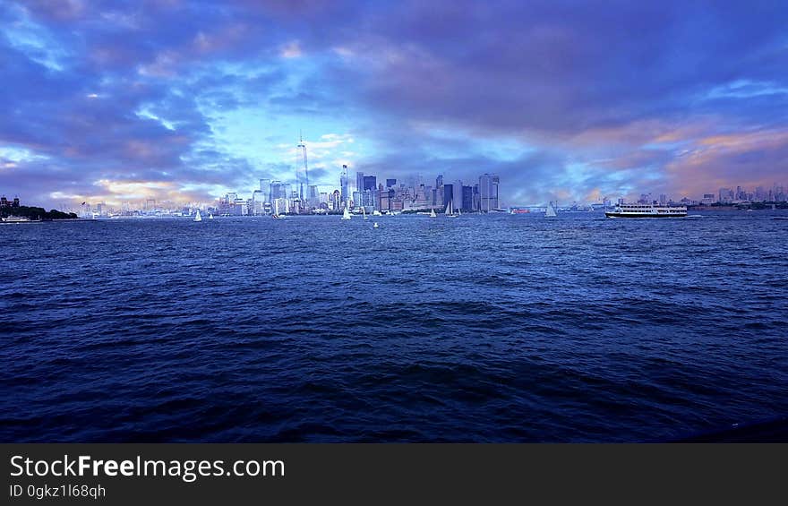 A modern cityscape viewed from a distance over water. A modern cityscape viewed from a distance over water.