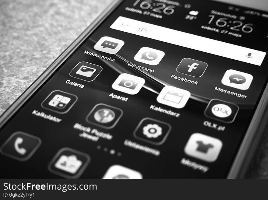 Apps on screen of smartphone in black and white.