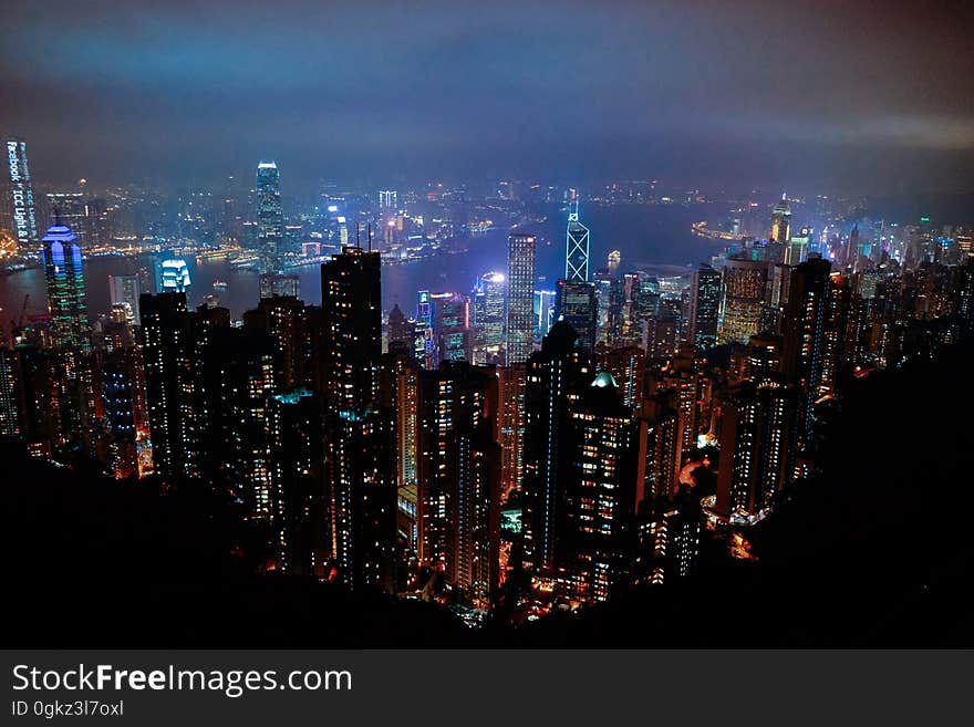 Aerial view over skyscrapers in city skyline illuminated at night. Aerial view over skyscrapers in city skyline illuminated at night.