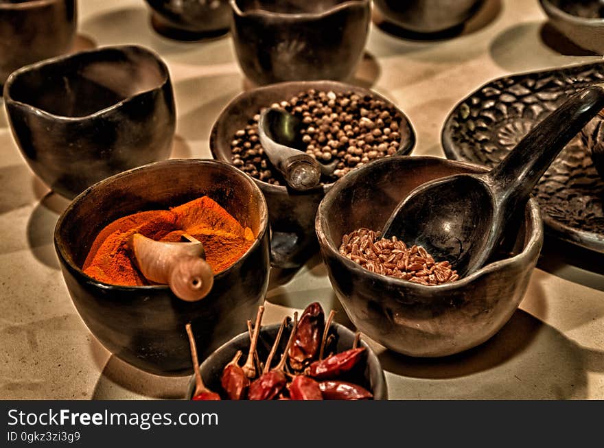 Black Ceramic Bowl With Different Kinds of Condiments