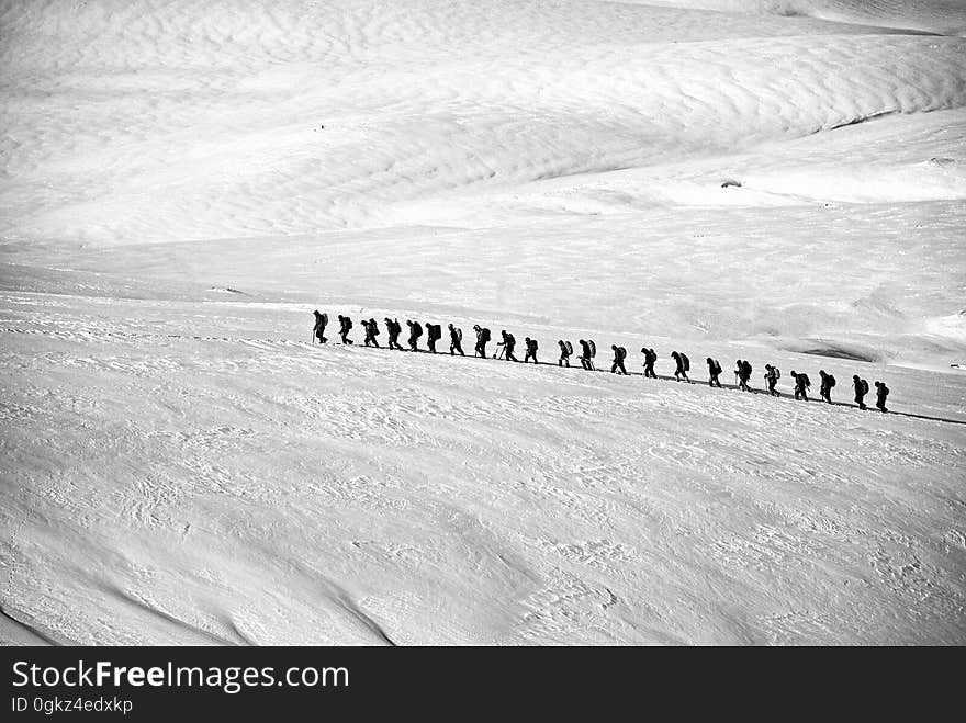 People Walking on Snow Field Grayscale Photography