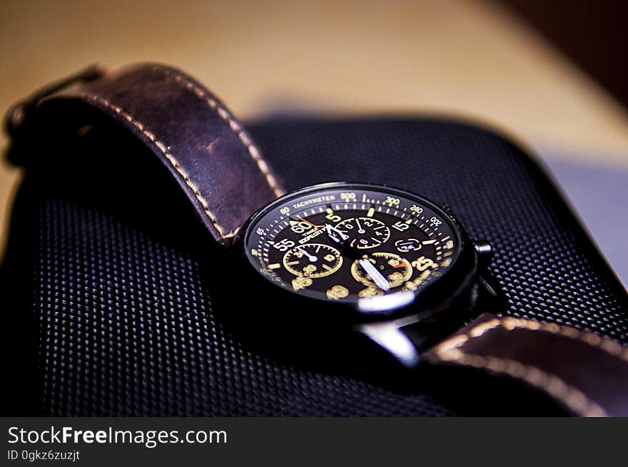 Close up of wristwatch with leather strap on smartphone. Close up of wristwatch with leather strap on smartphone.