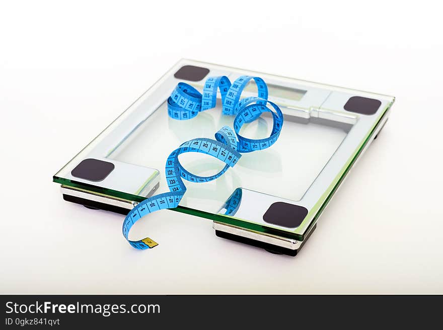 Blue Tape Measuring on Clear Glass Square Weighing Scale