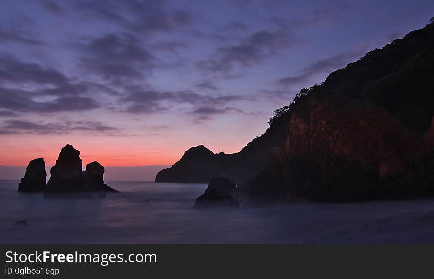 Silhouette Photo of Cliff during Sunset