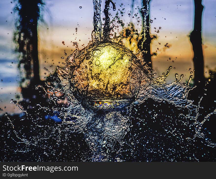 Close up of water splashing in front of sunset on horizon. Close up of water splashing in front of sunset on horizon.