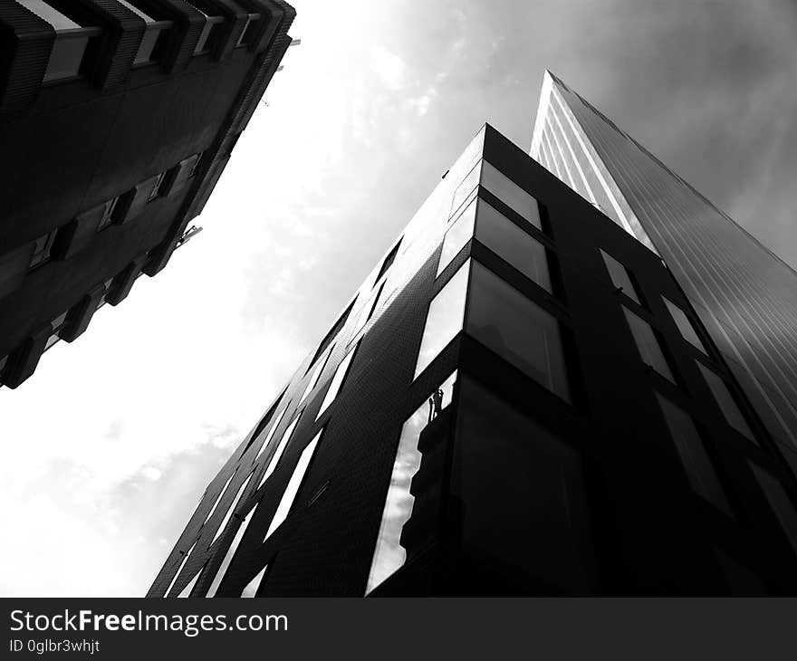 Facade of modern architecture against cloudy skies in black and white. Facade of modern architecture against cloudy skies in black and white.