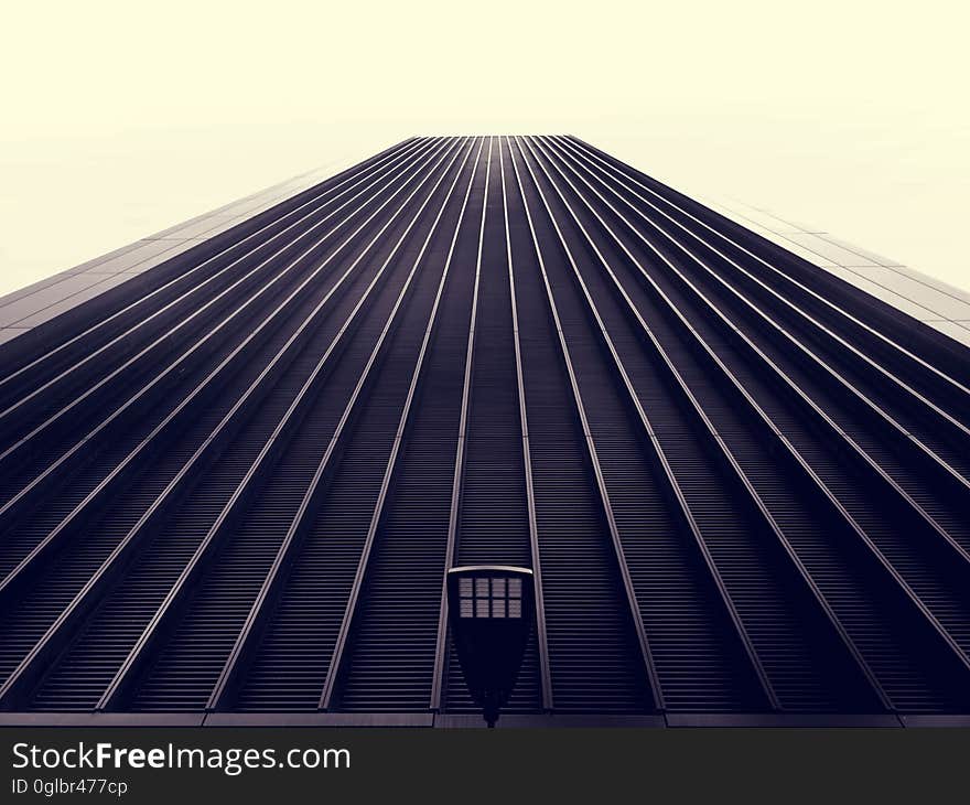 Exterior facade of high rise building against overcast skies.