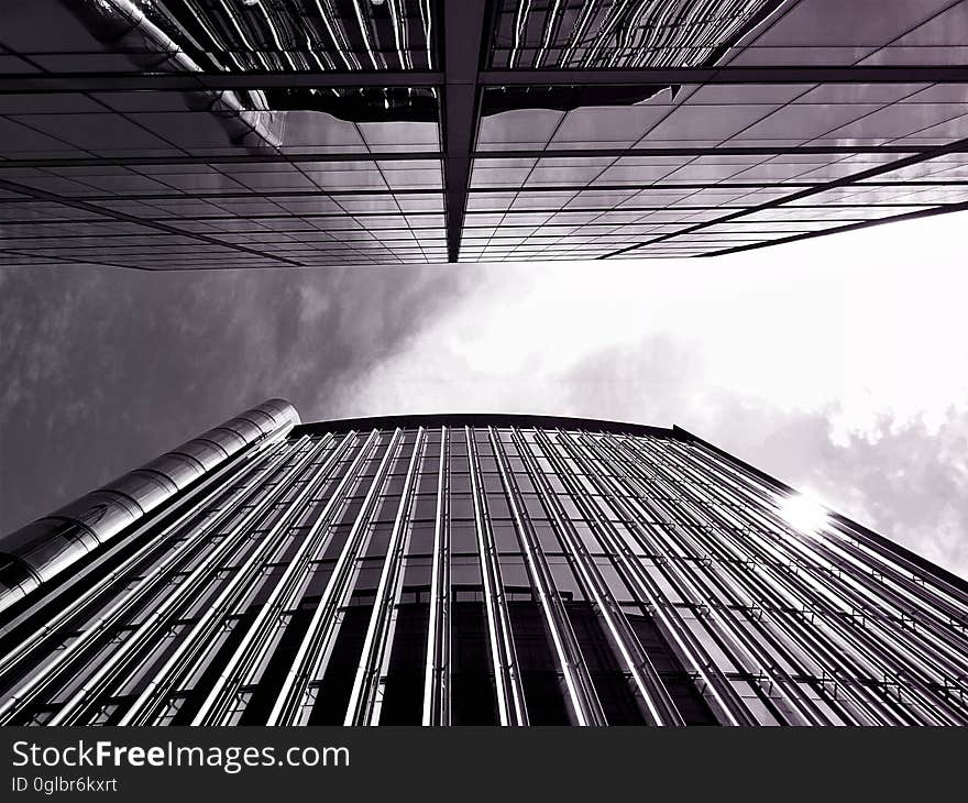 View of sky between two skyscraper buildings in black and white. View of sky between two skyscraper buildings in black and white.