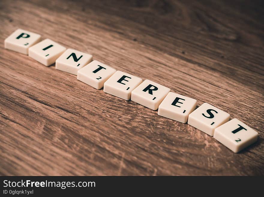 Pinterest spelled in Scrabble tiles on rustic wood table. Pinterest spelled in Scrabble tiles on rustic wood table.