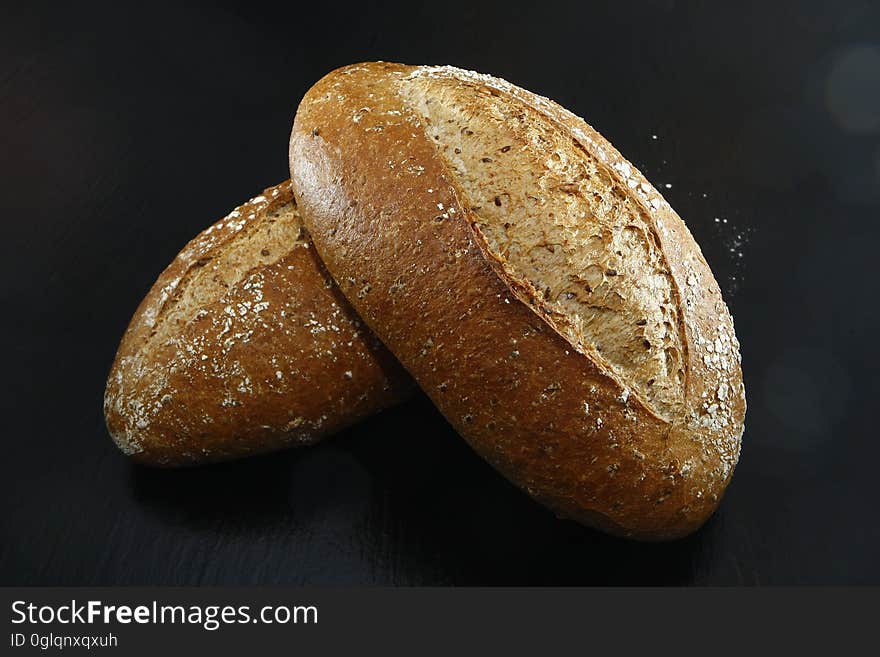 Closeup of loaves of bread isolated on a black background.