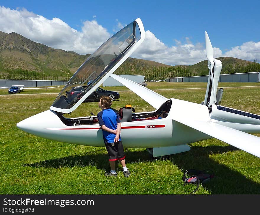 A child looks into the cockpit of an airplane. A child looks into the cockpit of an airplane.