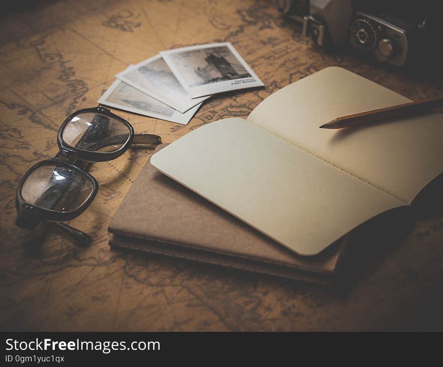 Black Frame Eyeglasses Beside Open Book