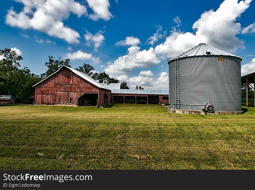 Gray Metal Water Tank Under Clear White Blue Sky during Daytime