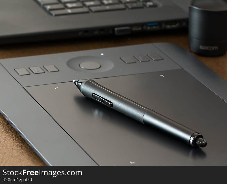 A close up of a black pen on a tablet. A close up of a black pen on a tablet.