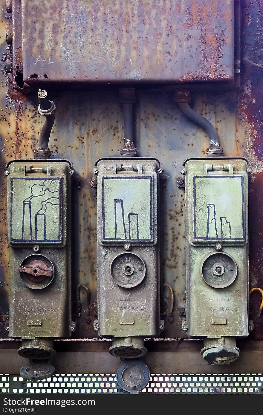 Smokestack illustration in black on rusty metal fuse boxes. Smokestack illustration in black on rusty metal fuse boxes.