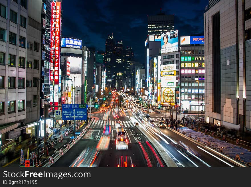 City streets illuminated with neon and blur of lights from traffic. City streets illuminated with neon and blur of lights from traffic.