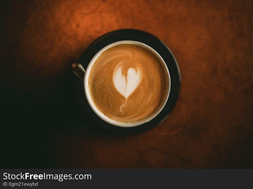 Overhead of cup of latte with heart shape in foam. Overhead of cup of latte with heart shape in foam.