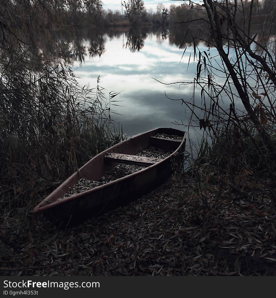 Wooden canoe on banks of river. Wooden canoe on banks of river.