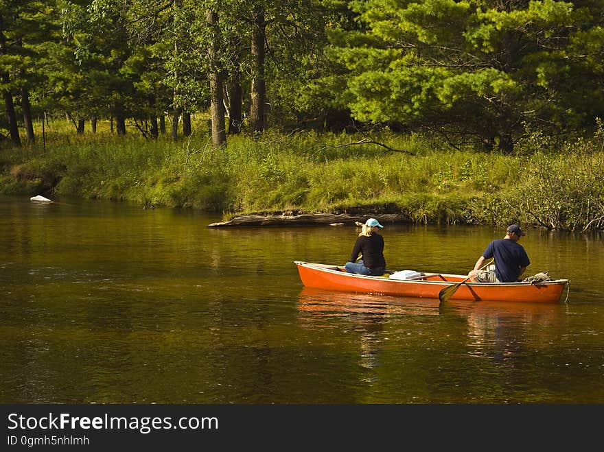 A couple on a kayak in a river. A couple on a kayak in a river.