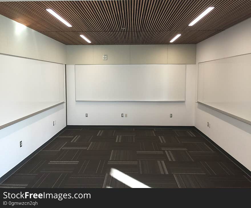 An empty room with lights on the ceiling.