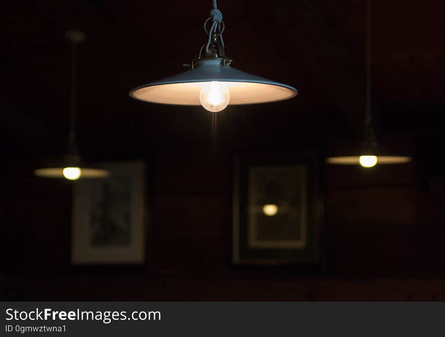 Hanging light fixtures, glowing softly in the darkness.