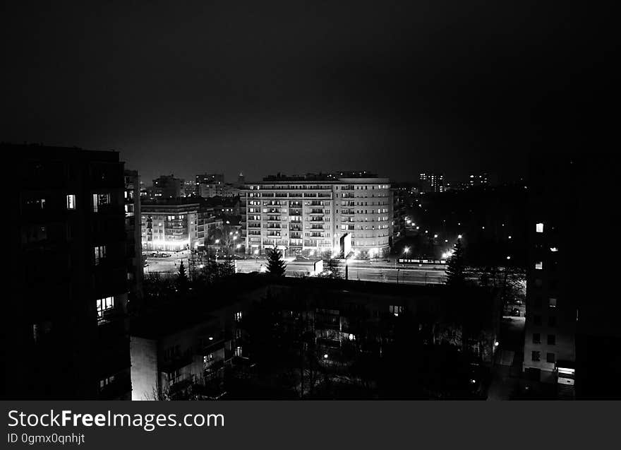 A panoramic view of city buildings at night.