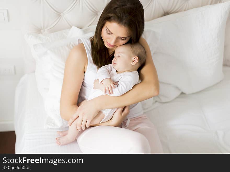 Young Mother Holding Her Newborn Daughter