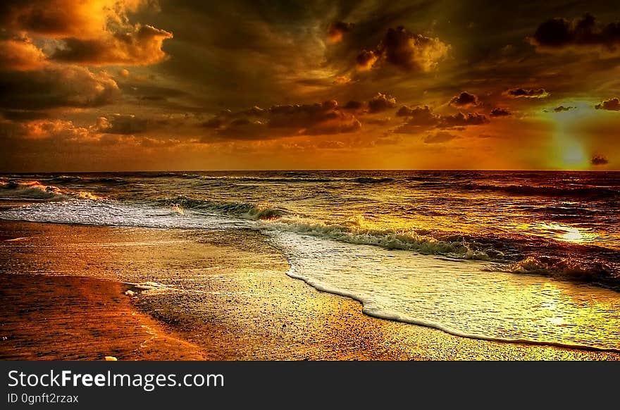 A beautiful sunset is reflected on a beach. A beautiful sunset is reflected on a beach.