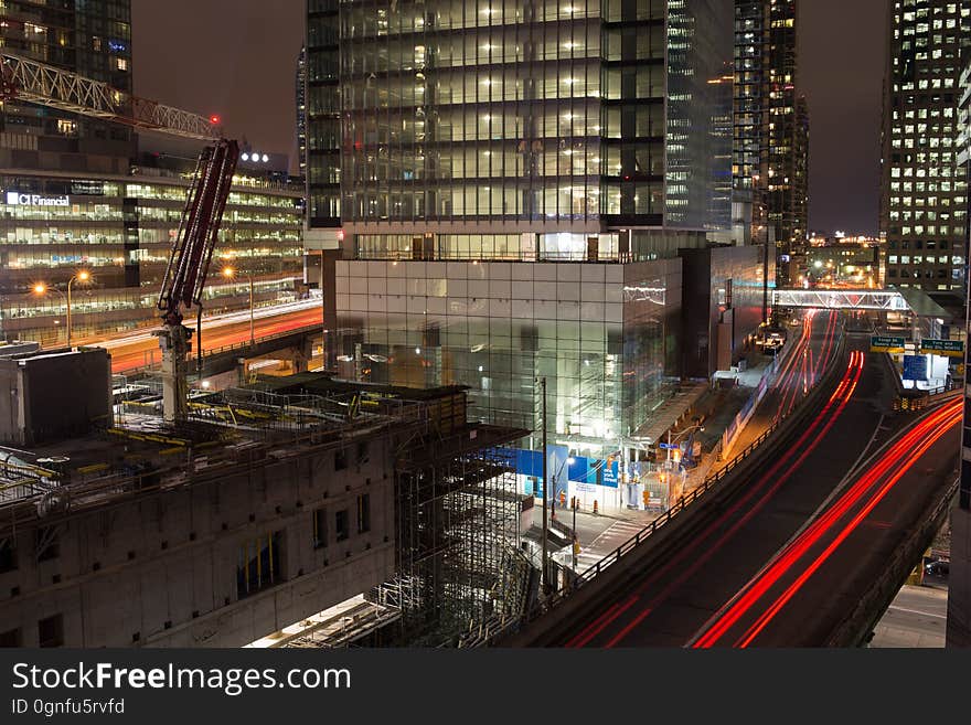 A night view of a city with traffic leaving light trails. A night view of a city with traffic leaving light trails.