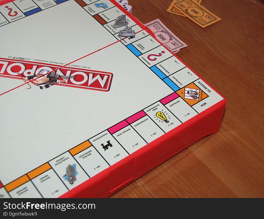 A game of Monopoly on table.