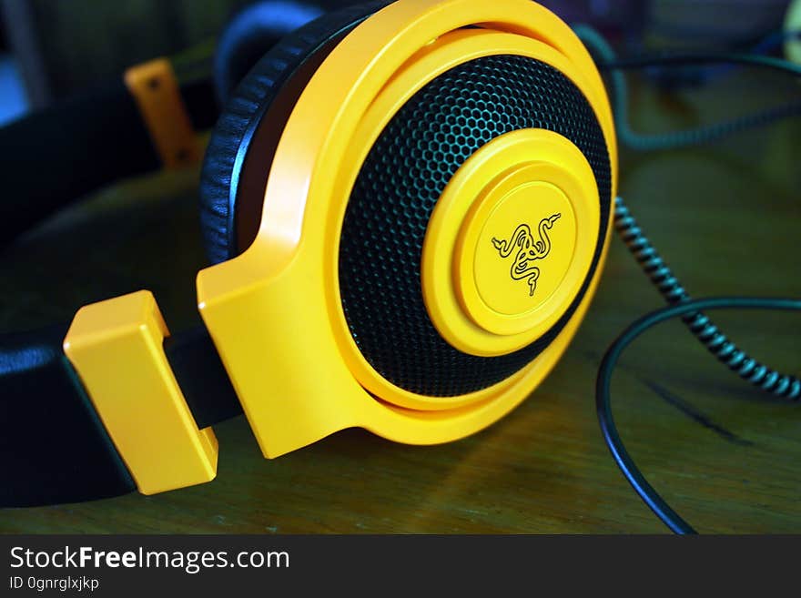 Close up of yellow and black stereo headphone speakers. Close up of yellow and black stereo headphone speakers.