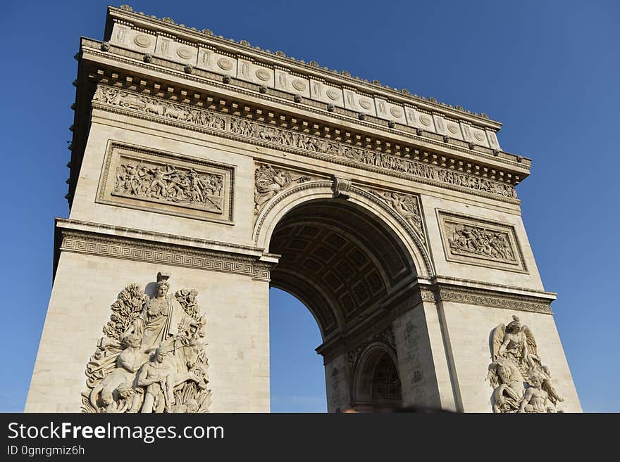 Arc de Triomphe in Paris, France against sunny blue skies. Arc de Triomphe in Paris, France against sunny blue skies.