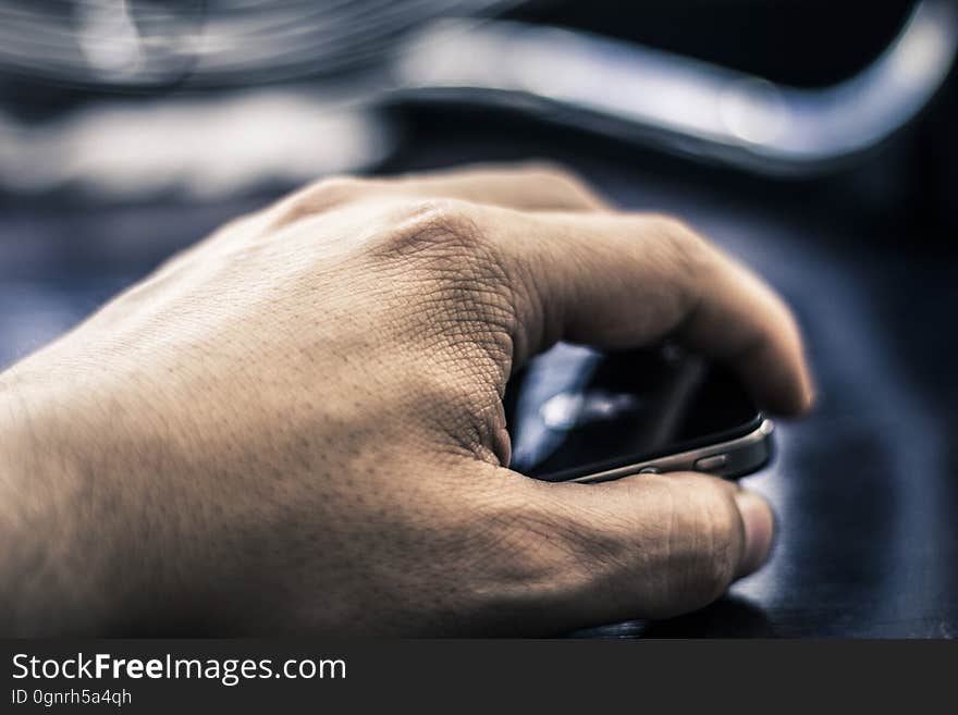 Close up of male hand holding smartphone.