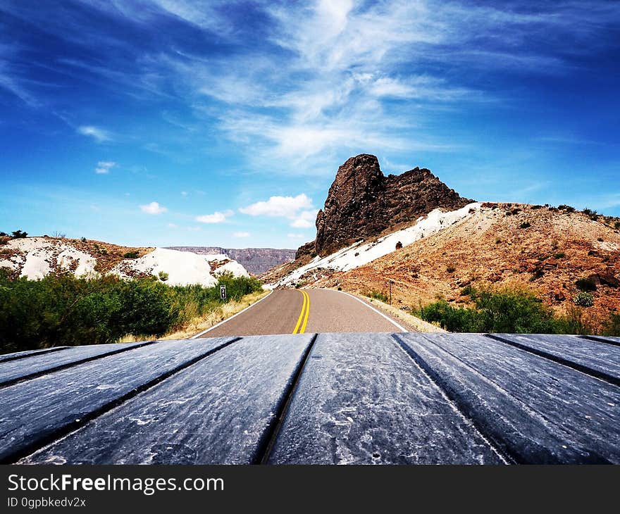 Scenic View of Mountain Road Against Blue Sky