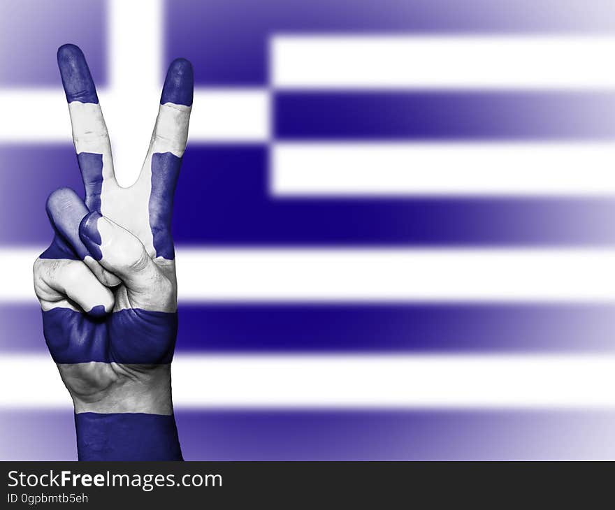 Hand painted in Greek flag colors making peace sign against flag background. Hand painted in Greek flag colors making peace sign against flag background.