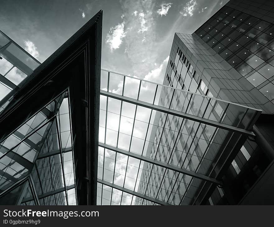 A view under modern buildings in the city in black and white.