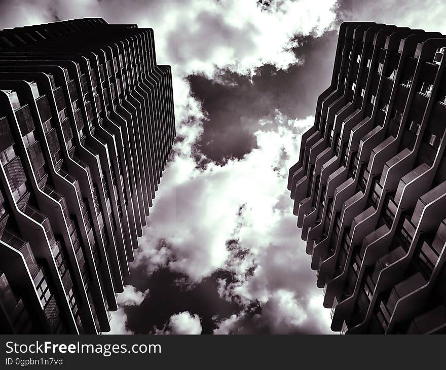 A black and white photo of two towering skyscrapers. A black and white photo of two towering skyscrapers.