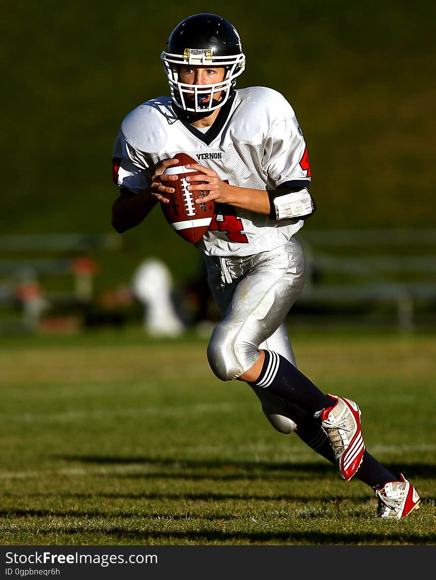 Man Holding Football While Running