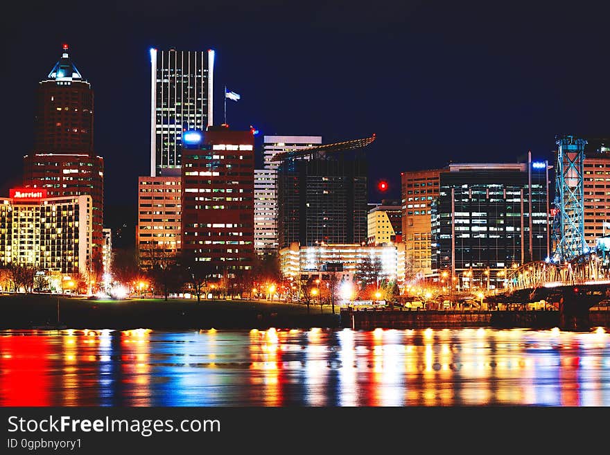 Downtown Portland at night, reflected on the waterfront.