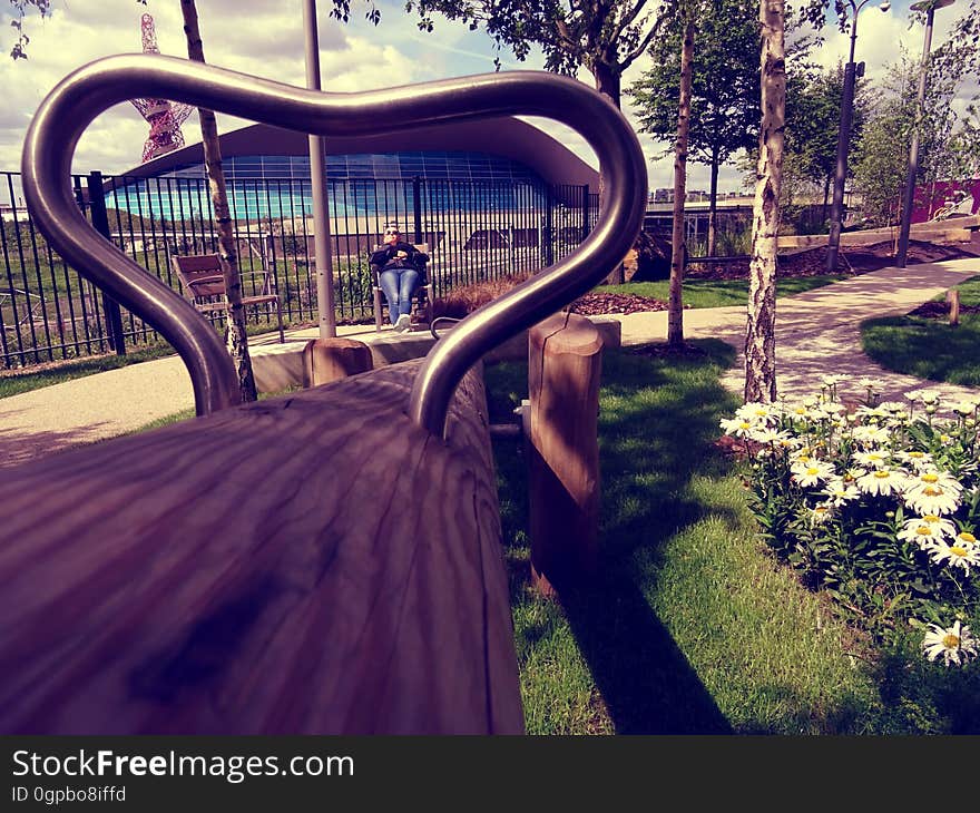 A park with a bench seen through a metal frame. A park with a bench seen through a metal frame.